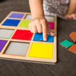 little-girl-s-hands-playing-with-wood-mosaic-sofa-educational-games-montessori-preschool-early-develop_114561-488