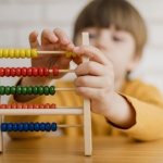 defocused-child-learning-how-count-using-abacus_23-2148524671
