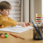 side-view-child-home-being-tutored-through-laptop_23-2148524662