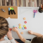 top-view-child-tutor-learning-about-numbers-letters_23-2148524549